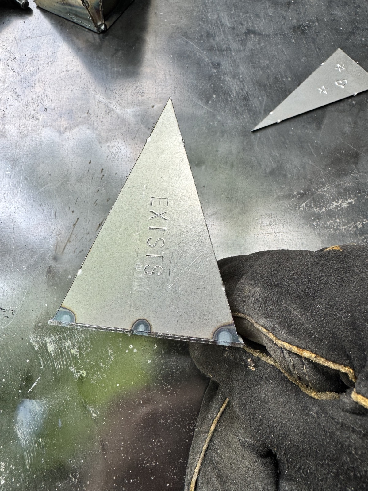 the first panel tacked to the base plate, letters stamped into the face